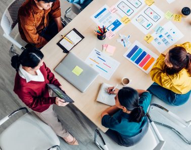 top view ux developer and ui designer presenting mobile app interface with success growth income graph on tablet in meeting at modern office.Creative digital development mobile app agency