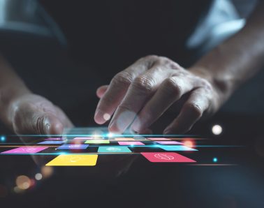 Man using smartphone with colourful mobile apps on virtual screen, application design, user interface, digital software development, IoT Internet of Things, business and technology concept